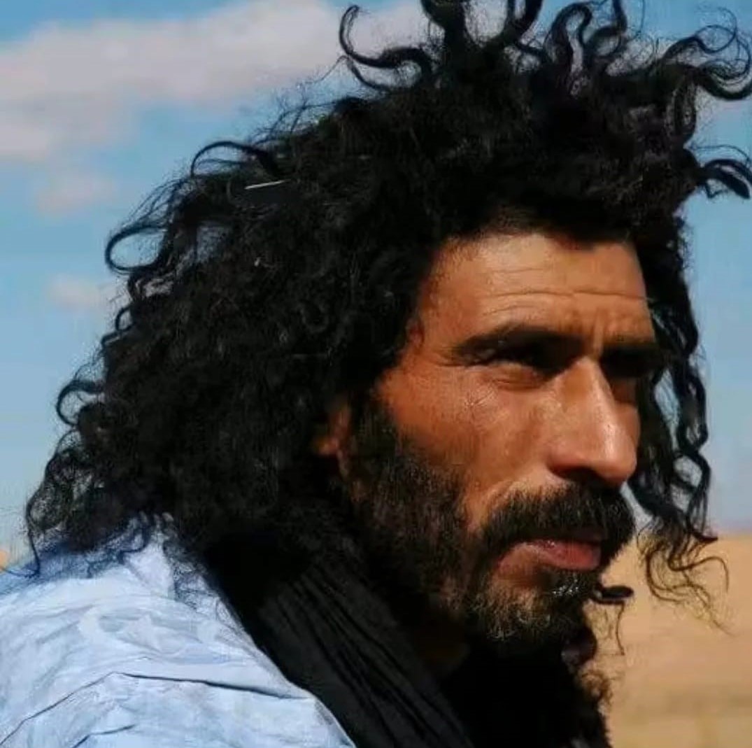 Ali, local Sahara guide with wind-swept hair