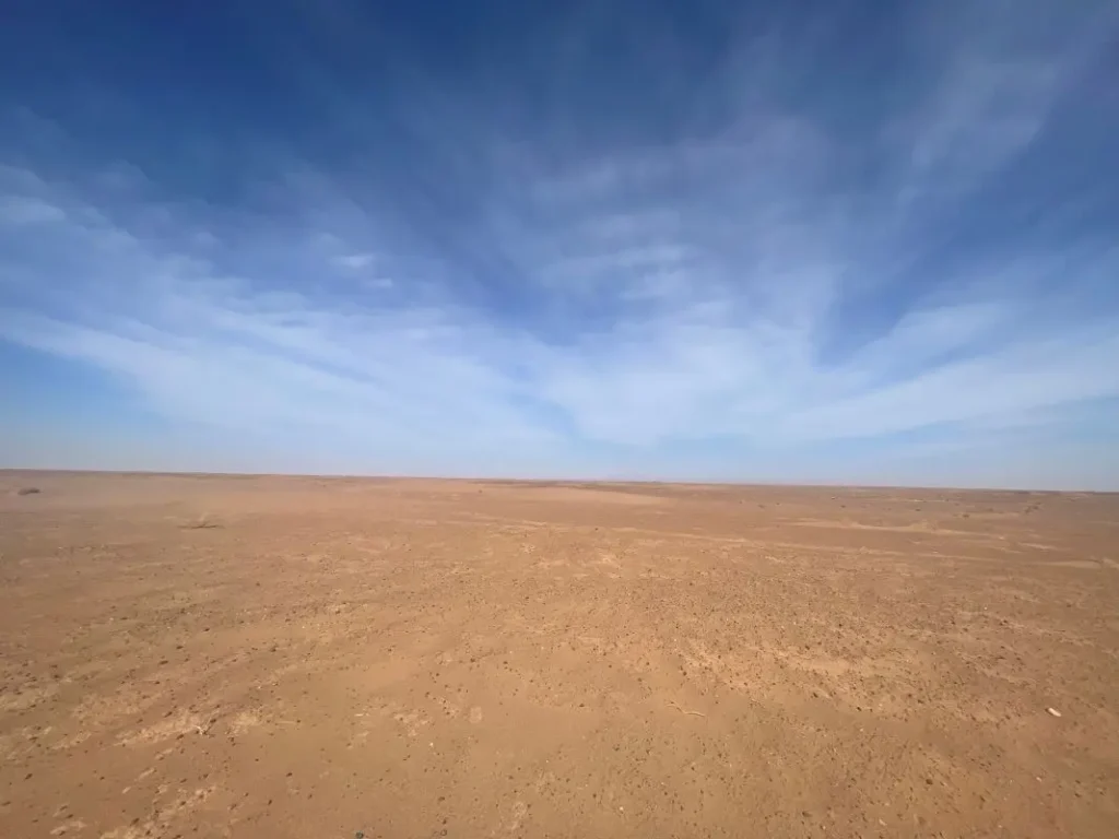 Endless sky meeting the sandy ground of the Sahara Desert in Morocco.