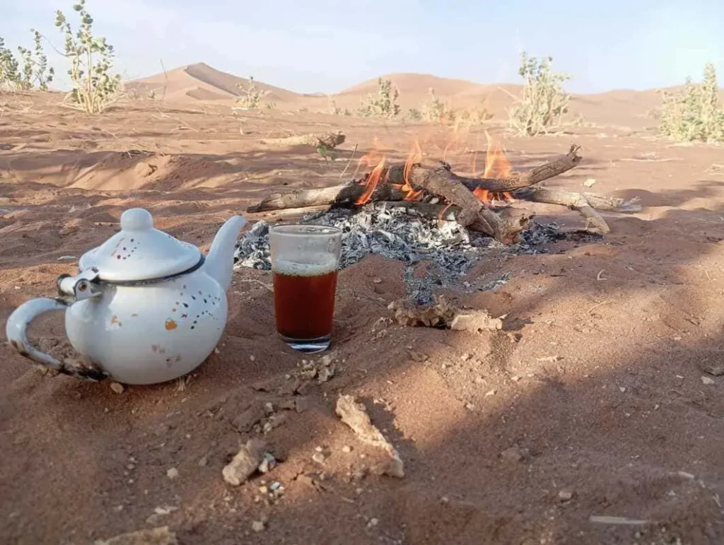 Traditional Moroccan tea served beside a desert fire during a 1-day 4x4 desert excursion